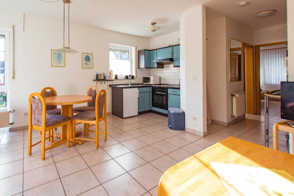 a kitchen with a table and chairs and a dining room at Ferienwohnung Sewenig in Müden