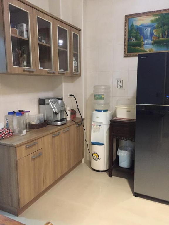 a kitchen with a black refrigerator and a counter top at Amicasa Guesthouse in Hualien City