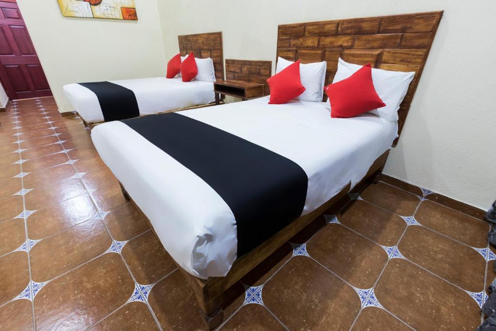Postel nebo postele na pokoji v ubytování Hotel Hacienda Tonalmain, Central Nueva