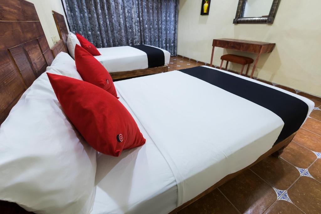 Postel nebo postele na pokoji v ubytování Hotel Hacienda Tonalmain, Central Nueva