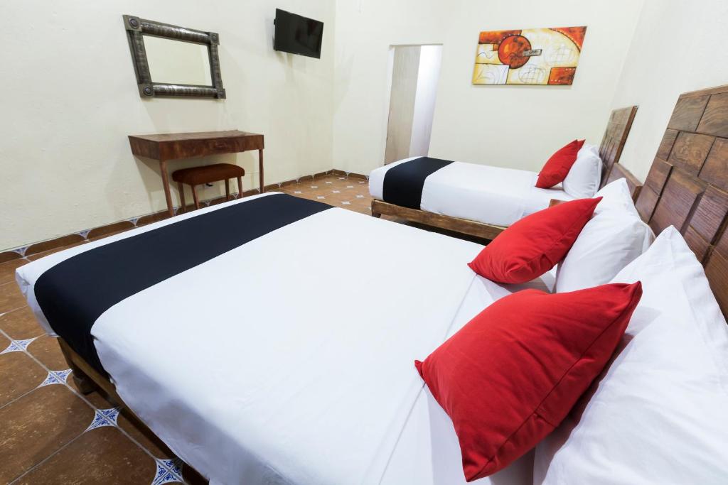 Postel nebo postele na pokoji v ubytování Hotel Hacienda Tonalmain, Central Nueva