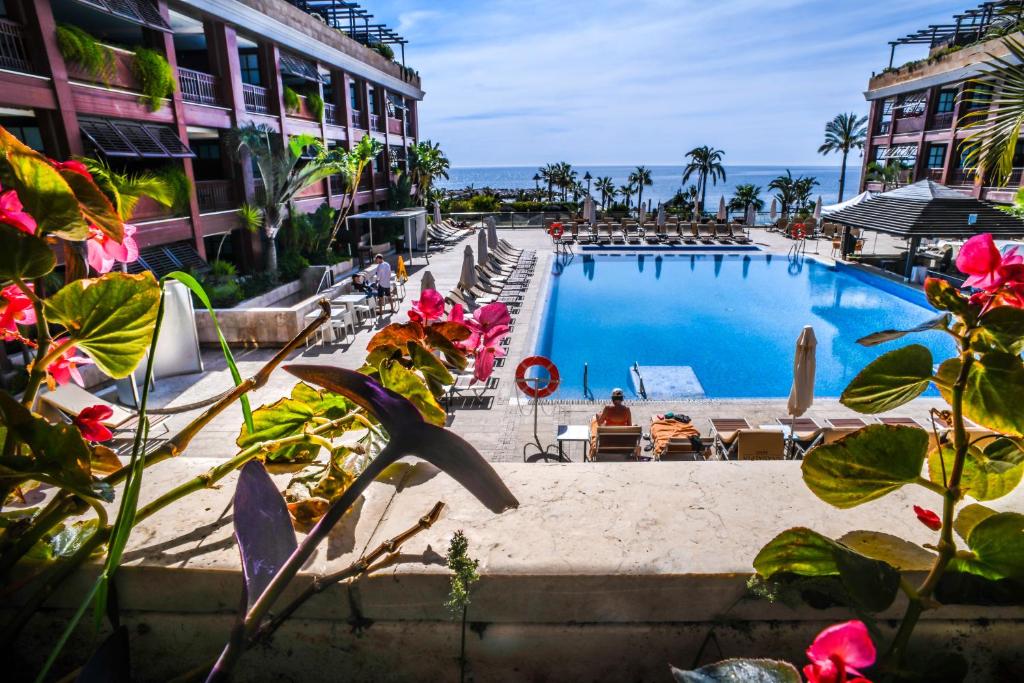 a large swimming pool next to a building at Gran Hotel Guadalpín Banus in Marbella