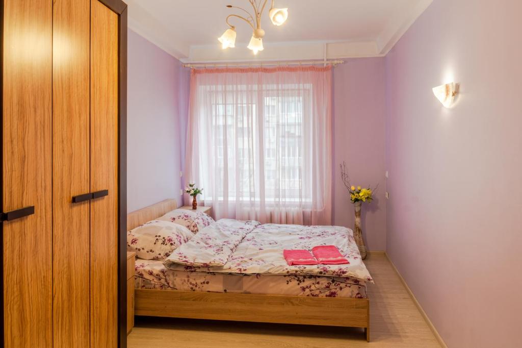 a small bedroom with a bed and a window at 112 вулиця Велика Васильківська in Kyiv