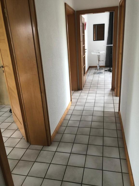 a hallway with a tile floor in a room at Rüsgen Ferienwohnung in Schwalmtal