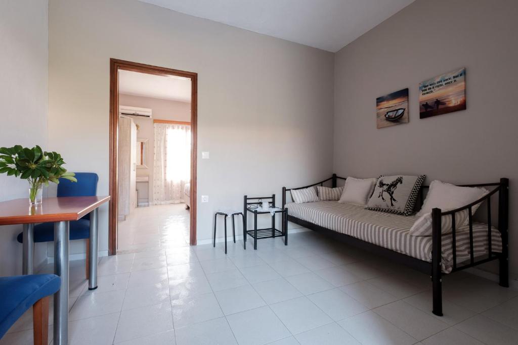 a living room with a bed and a table at Hotel Club Maria Sidari in Sidari