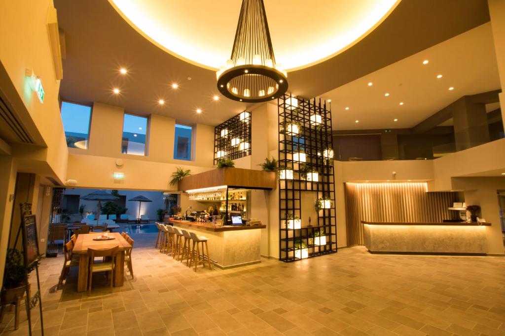 ein Esszimmer mit einem Tisch und einem Weinkeller in der Unterkunft Parasol Luxury Hotel & Suites Adults Only in Karpathos