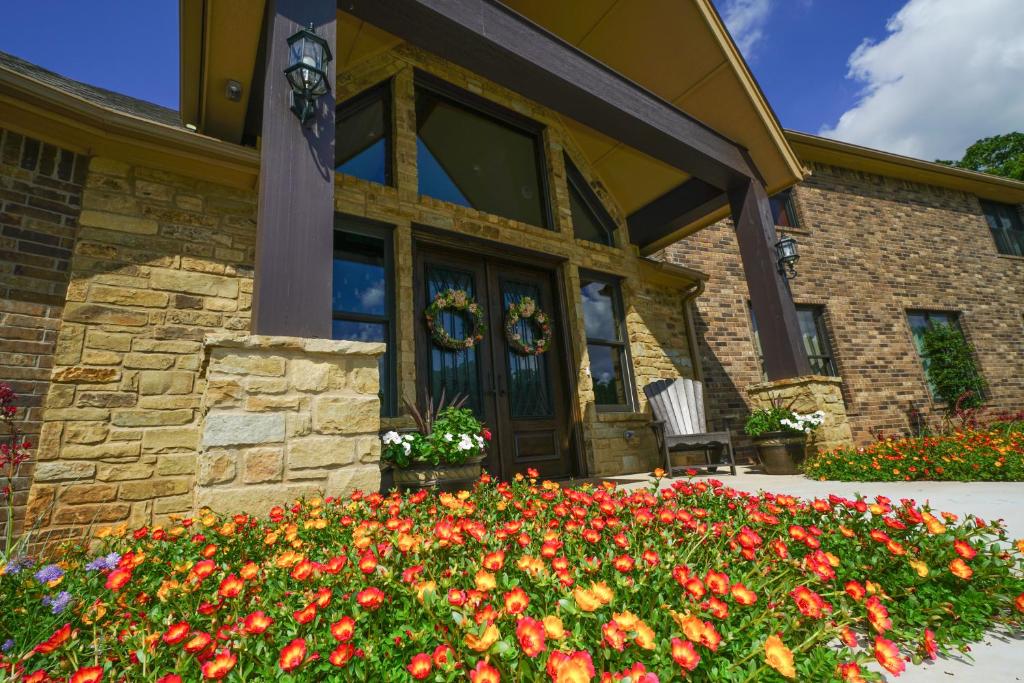 a house with flowers in front of it at Hidden Meadows Bed and Breakfast in Stillwater