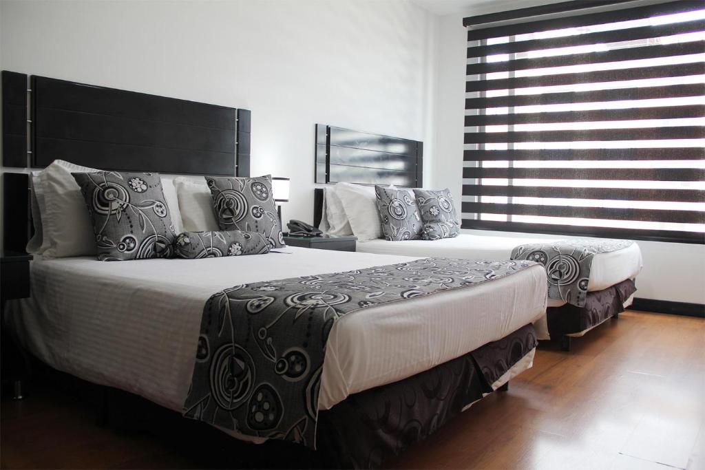 Postel nebo postele na pokoji v ubytování Hotel Santafe Real