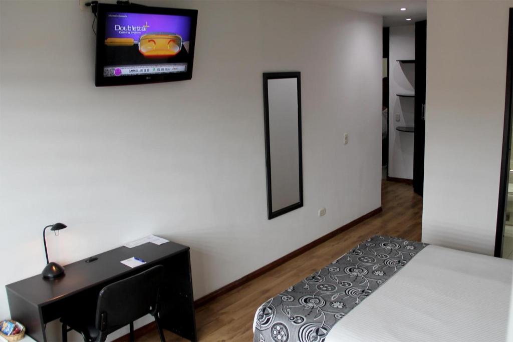 Postel nebo postele na pokoji v ubytování Hotel Santafe Real