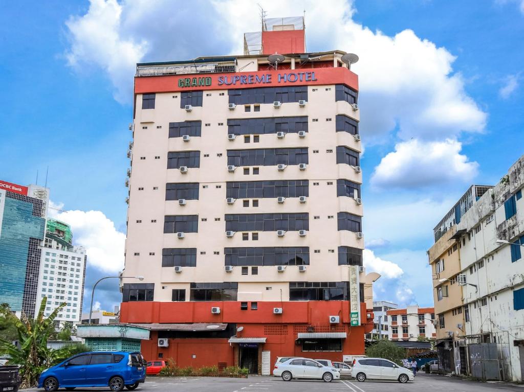 a building with a sign on the top of it at Grand Supreme Hotel in Kuching