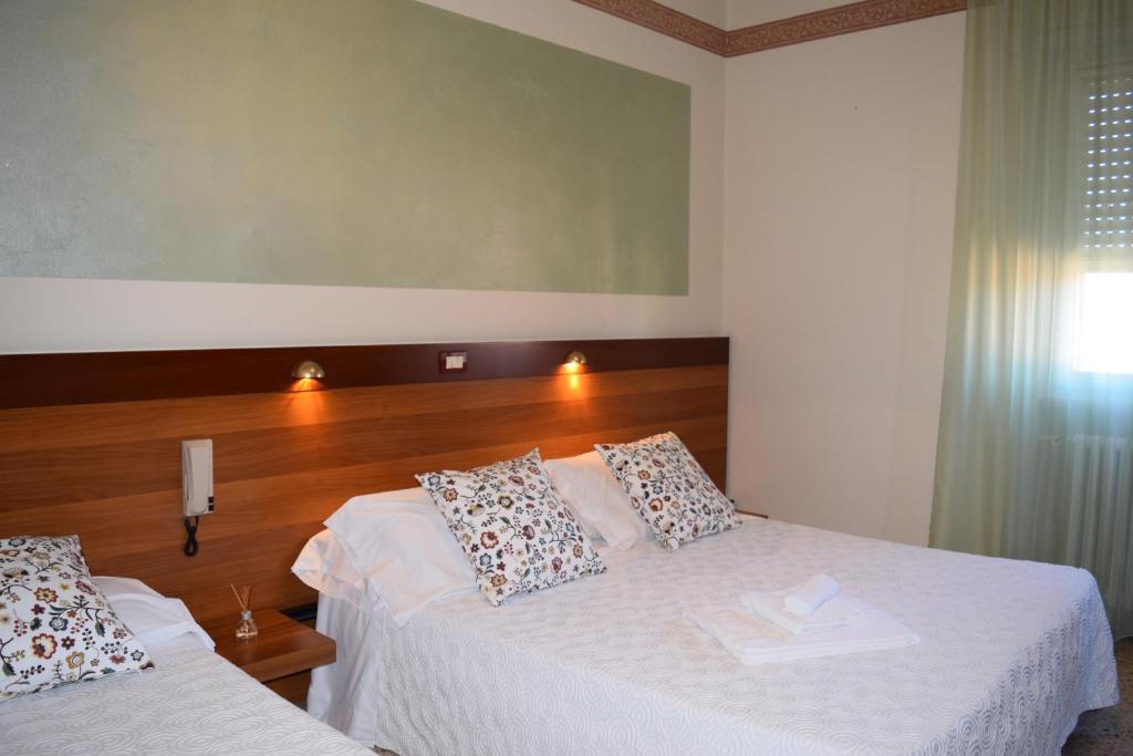 Posteľ alebo postele v izbe v ubytovaní Albergo Trattoria Fioravante