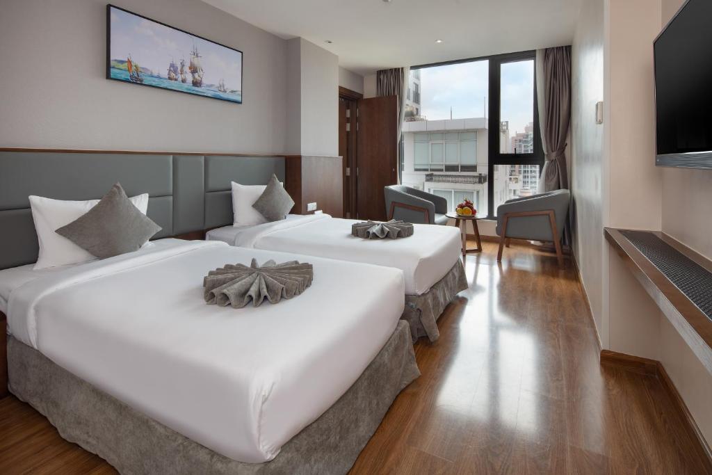 Giường trong phòng chung tại DTX Hotel Nha Trang