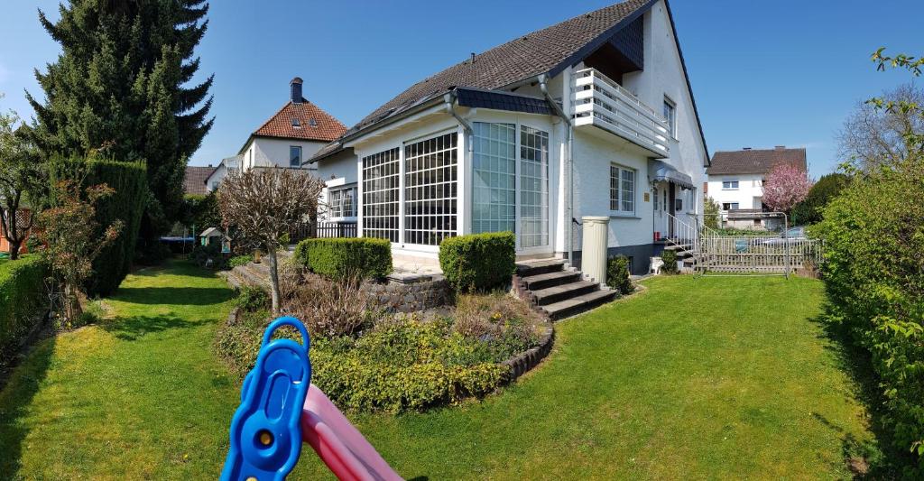 a house with a pair of scissors in the yard at Ferienhaus Anja Bad Pyrmont in Bad Pyrmont