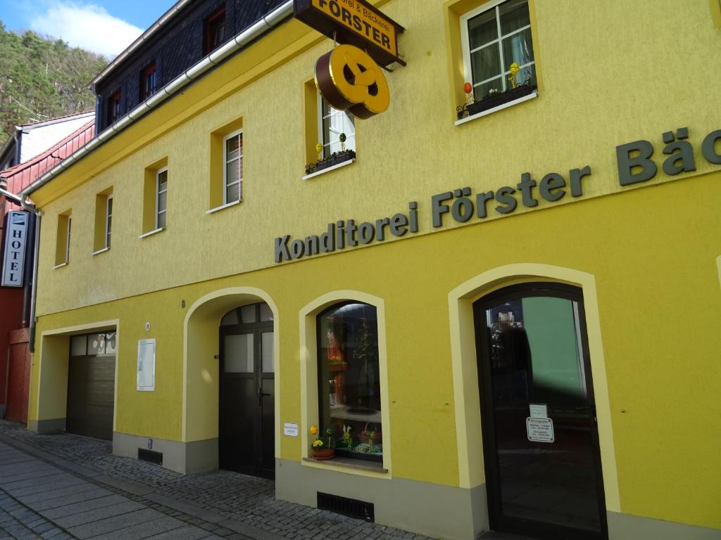 a yellow building with a pumpkin sign on it at Ferienwohnung Bäckerei Förster in Bad Schandau