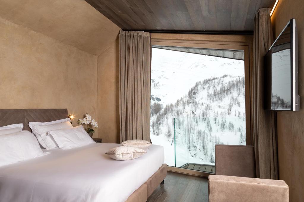 Postel nebo postele na pokoji v ubytování Bergman Mountain Hotel