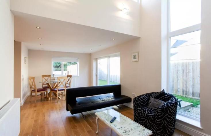 a living room with a couch and a table at Luxury 2 Bedroom Apartment in Peaceful Location in Cardiff