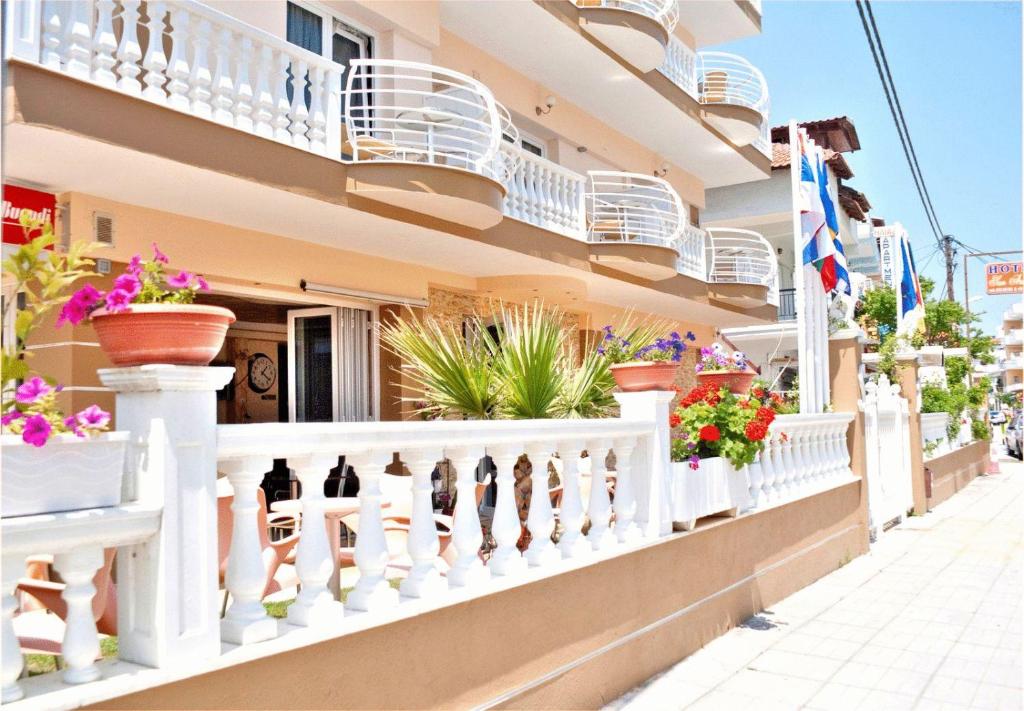 a balcony of a building with potted plants on it at Hotel San Antonio in Paralia Katerinis