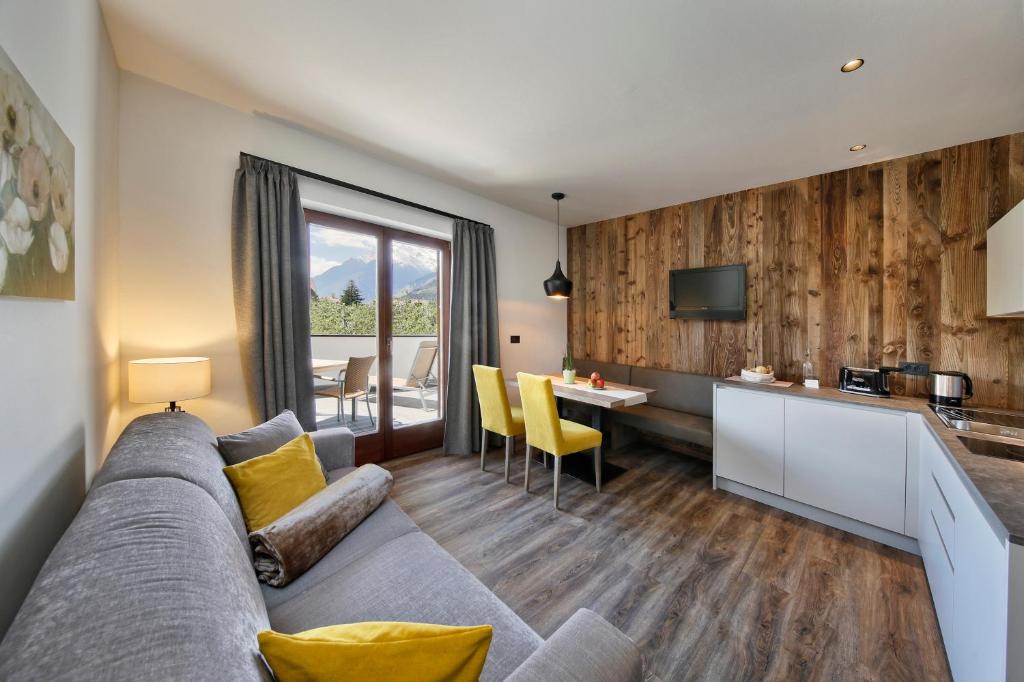 un soggiorno con divano e una cucina di Schlettererhof a Tirolo