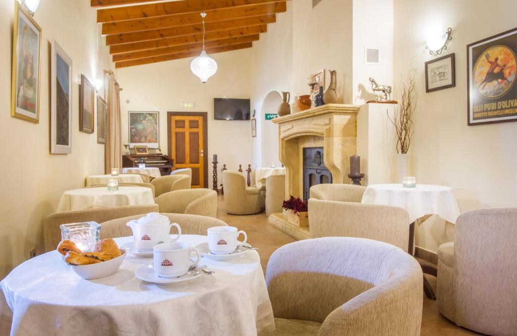a dining room with tables and chairs and a fireplace at Hotel Tossal d'Altea in Altea