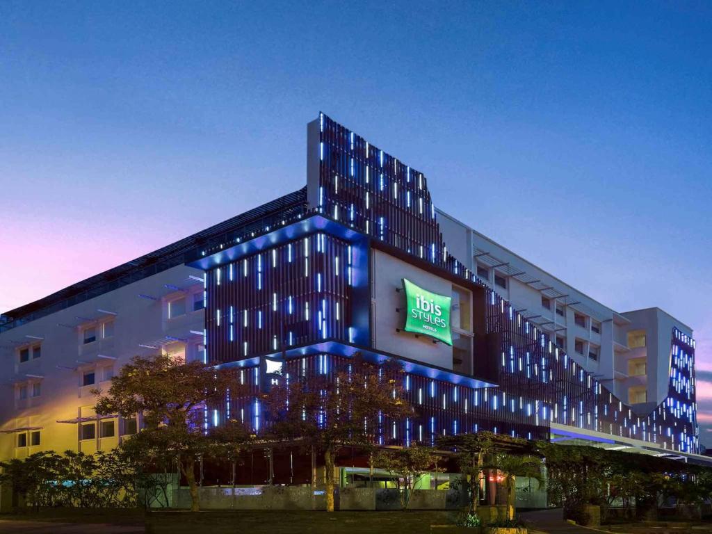 a large building with a clock on the front of it at ibis Styles Yogyakarta in Yogyakarta