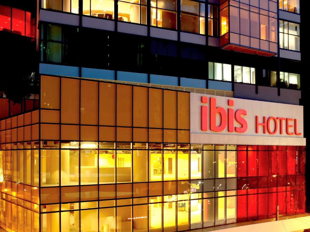a building with a bus hotel sign on it at Ibis Hong Kong Central & Sheung Wan in Hong Kong