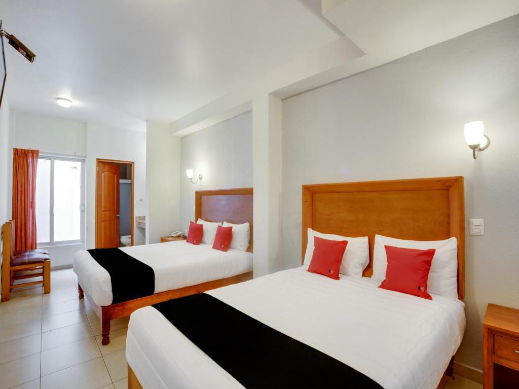 Postel nebo postele na pokoji v ubytování Hotel Patzcuaro