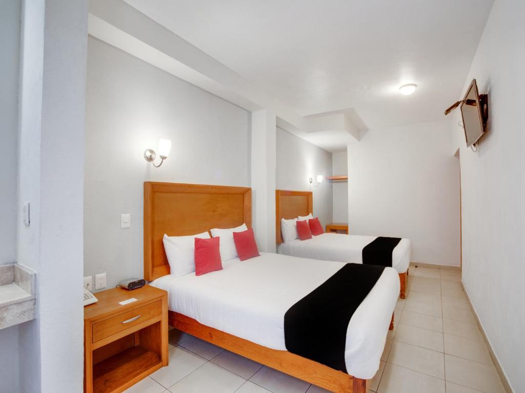 Postel nebo postele na pokoji v ubytování Hotel Patzcuaro