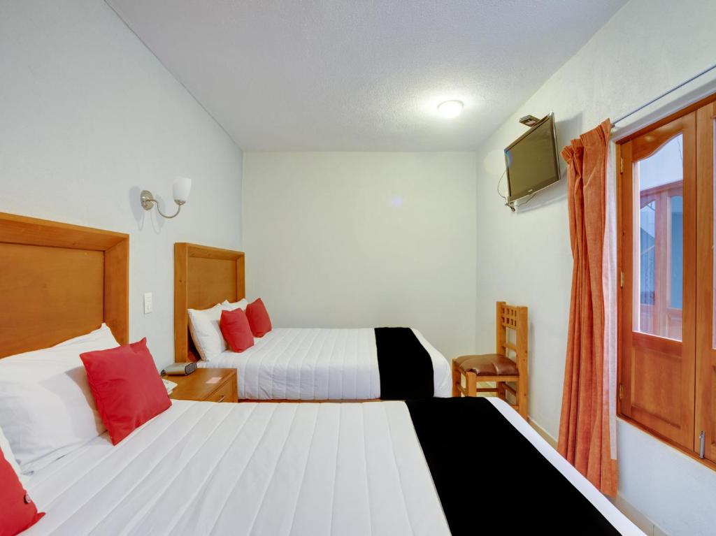 Postel nebo postele na pokoji v ubytování Hotel Patzcuaro