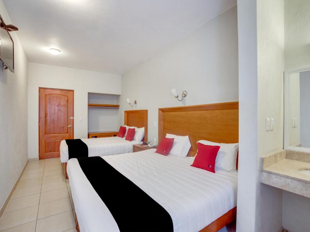 Postel nebo postele na pokoji v ubytování Hotel Patzcuaro