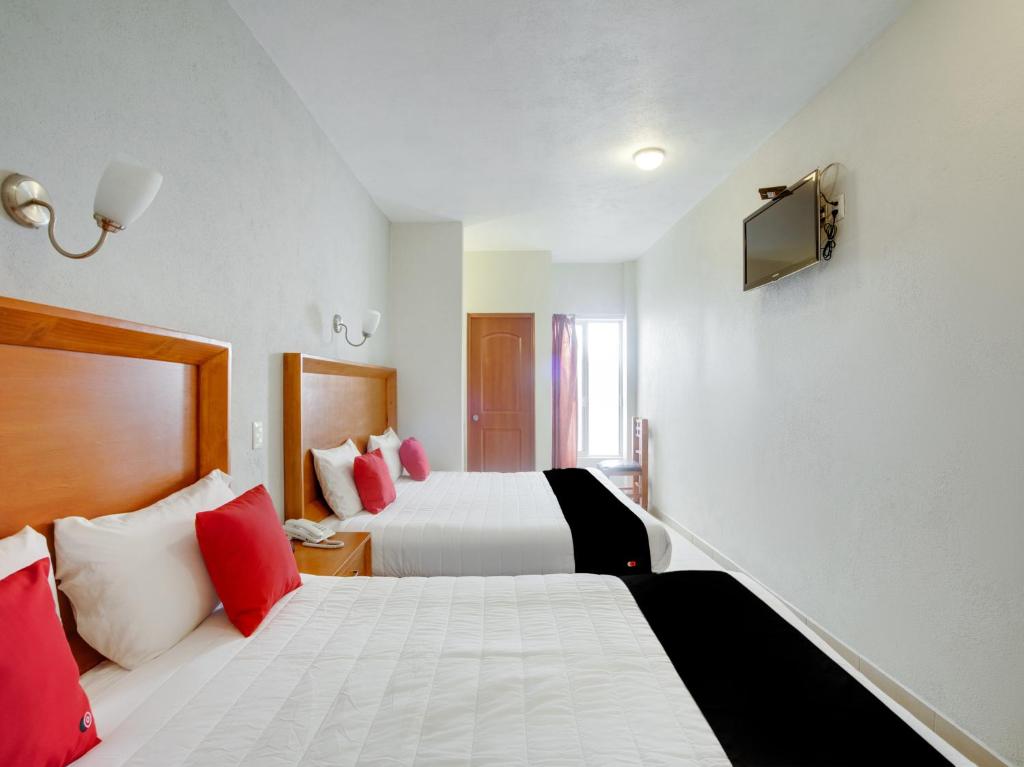 Postel nebo postele na pokoji v ubytování Hotel Patzcuaro