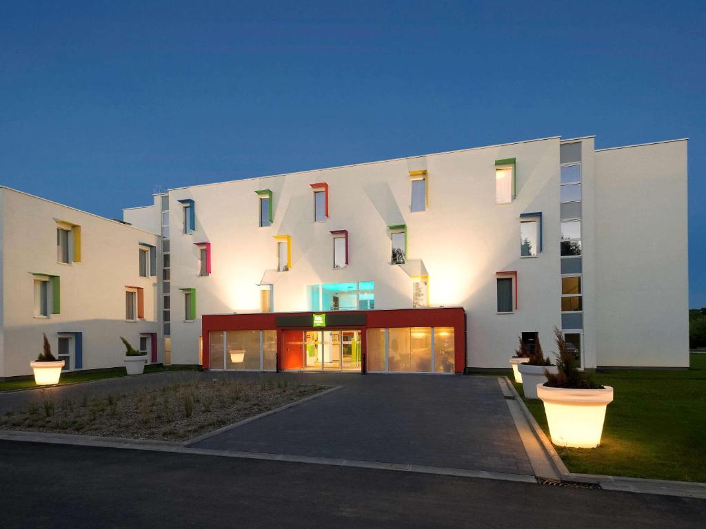 a large white building with colorful windows at ibis Styles Nivelles in Nivelles