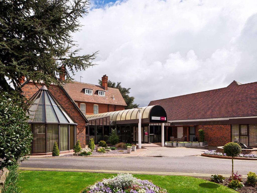 a large brick building with a building at Mercure Hull Grange Park Hotel in Hull