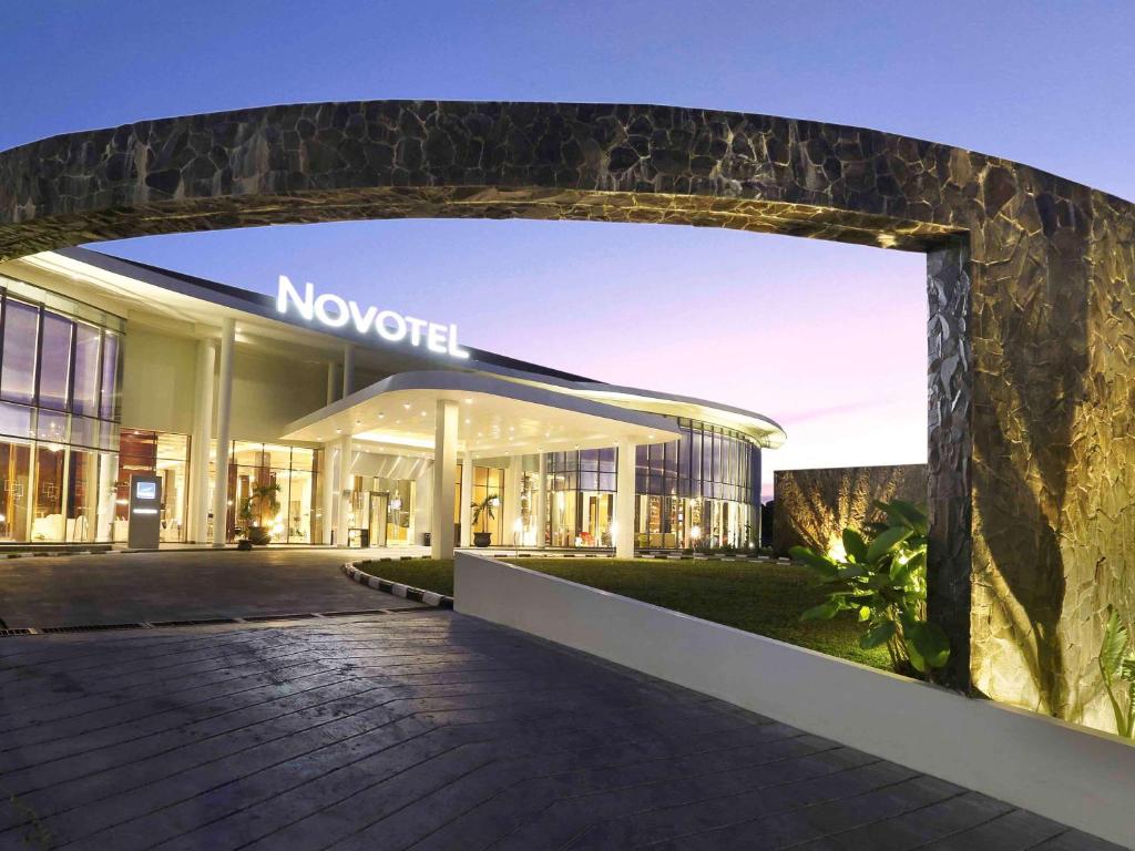 a modern building with an archway in front of it at Novotel Banjarmasin Airport in Banjarbaru