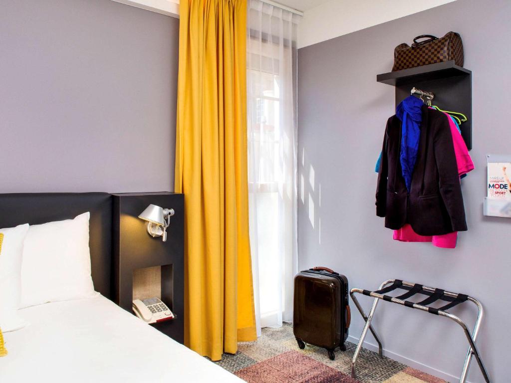 Postel nebo postele na pokoji v ubytování ibis Styles Roanne Centre Gare