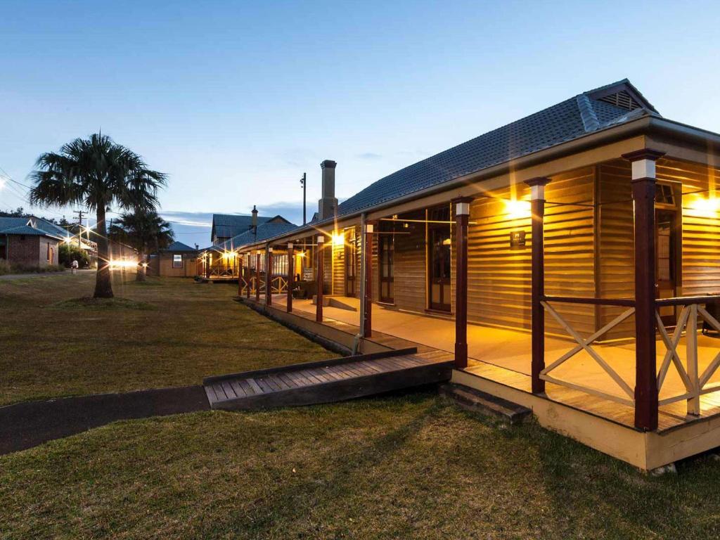 a wooden cabin with lights on the side of it at Q Station in Sydney