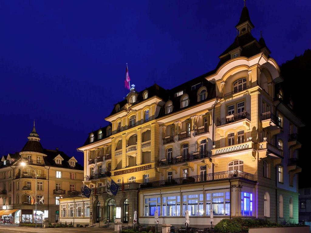 a large building is lit up at night at Hotel Royal St Georges Interlaken MGallery Collection in Interlaken