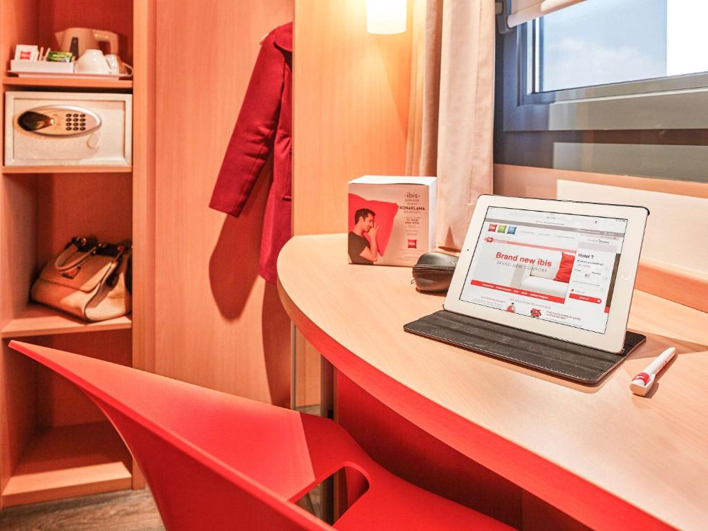 a laptop computer sitting on a counter in a room at ibis Ankara Airport Hotel in Ankara