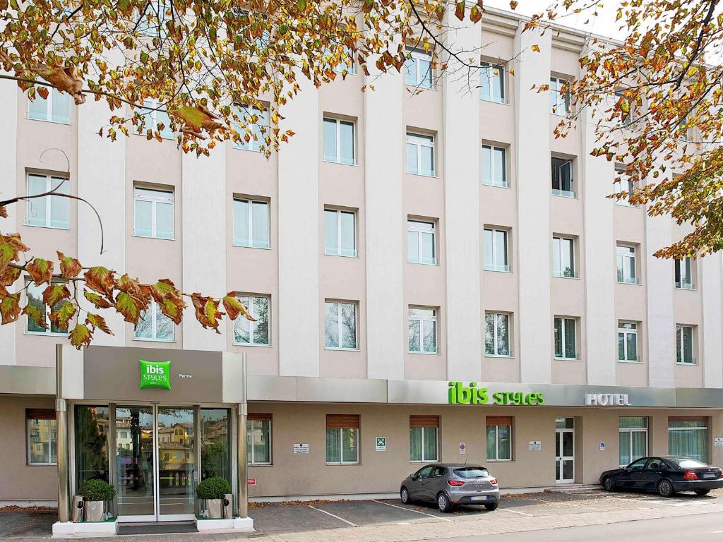 
cars parked in front of a building at Ibis Styles Parma Toscanini in Parma
