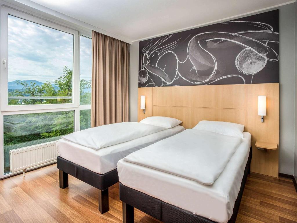 Postel nebo postele na pokoji v ubytování ibis Wörthersee