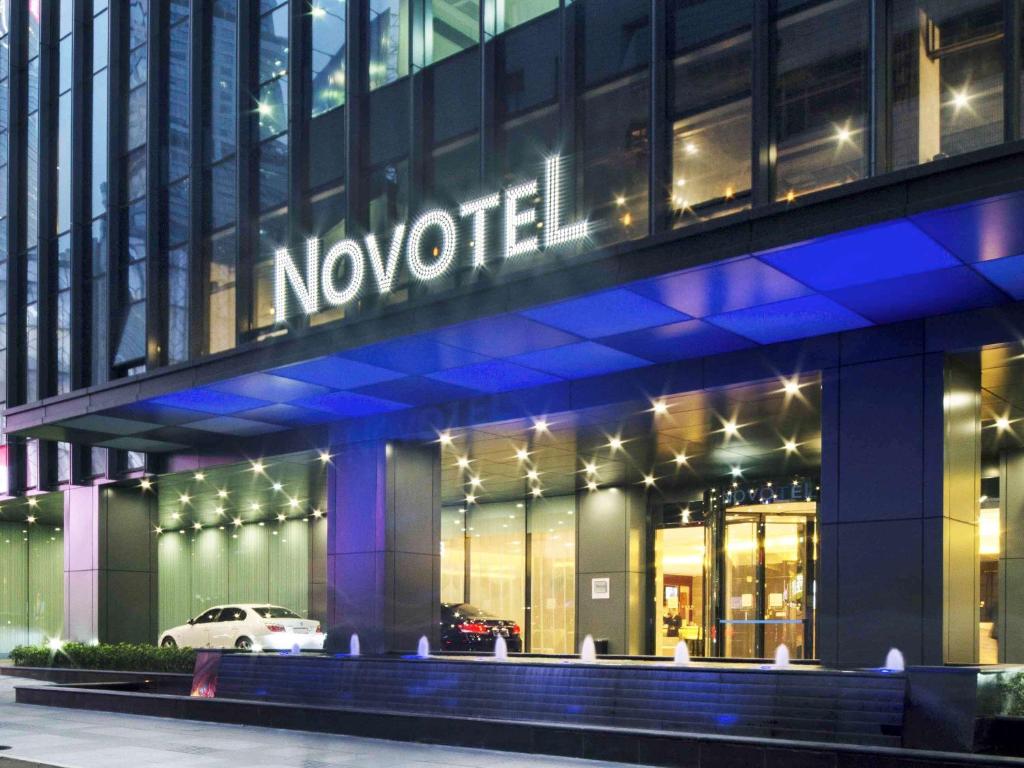 a nocet building with a sign on it at night at Novotel Nanjing Central in Nanjing