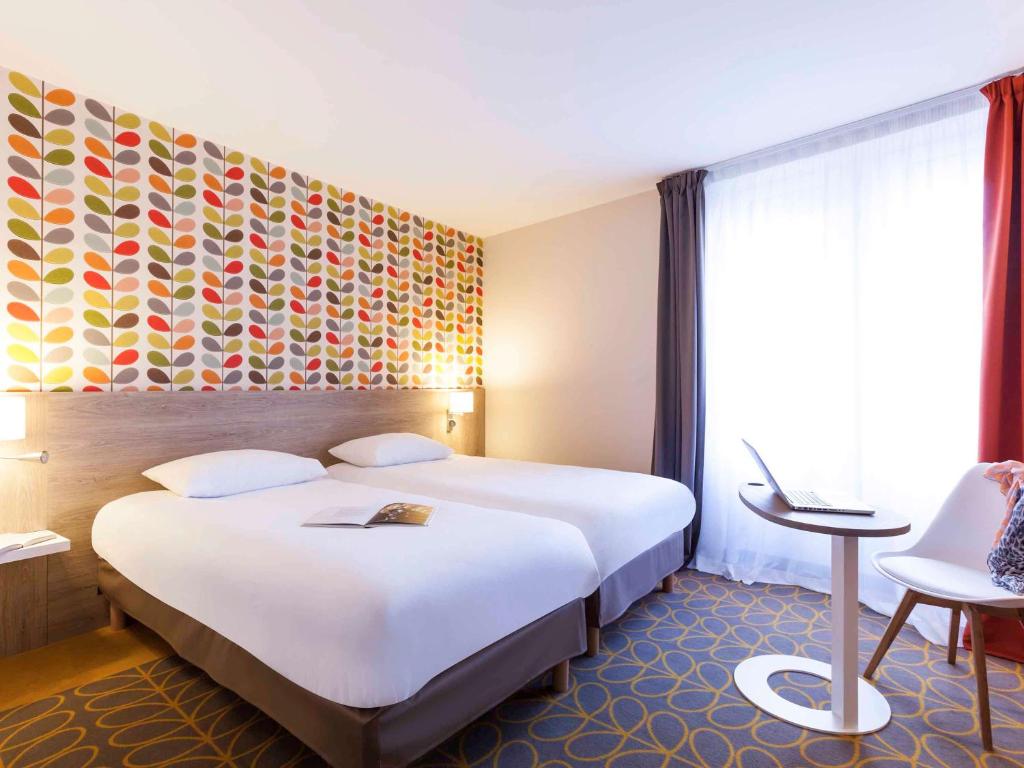 Postel nebo postele na pokoji v ubytování ibis Styles Chaumont Centre Gare