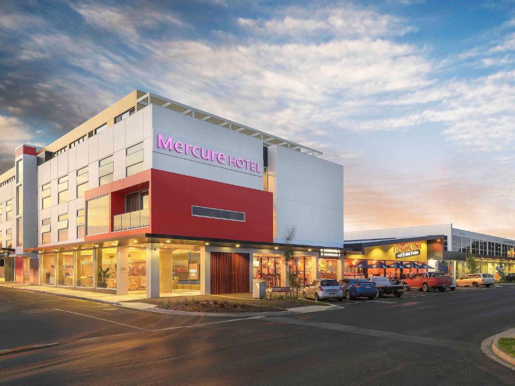 a large building with a store in a parking lot at Mercure Warragul in Warragul