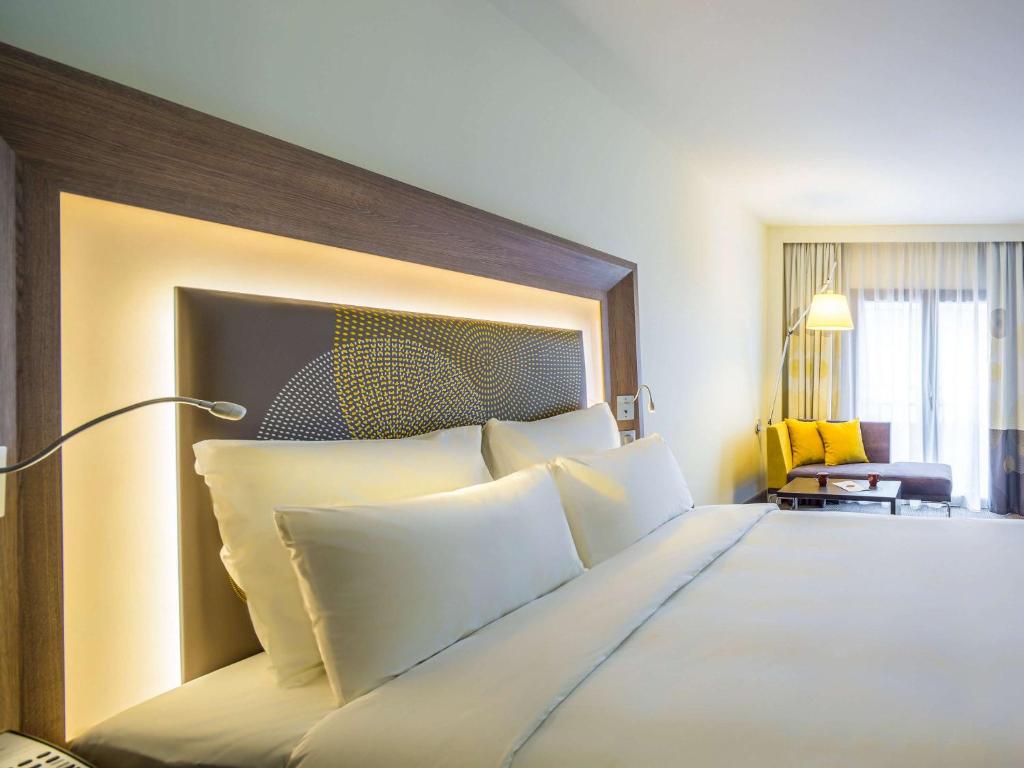 a bedroom with a large bed with white pillows at Novotel Istanbul Bosphorus Hotel in Istanbul