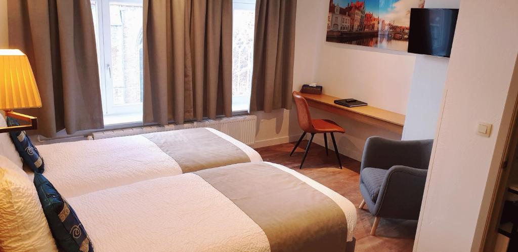 Postel nebo postele na pokoji v ubytování Hotel Asiris