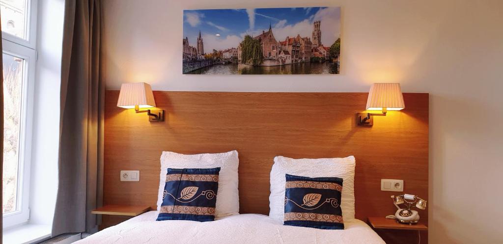 Postel nebo postele na pokoji v ubytování Hotel Asiris