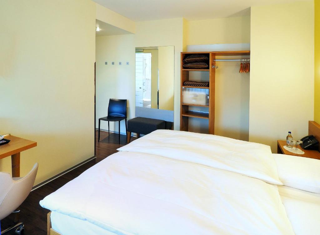 Postel nebo postele na pokoji v ubytování Sommerau-Ticino Swiss Quality Hotel