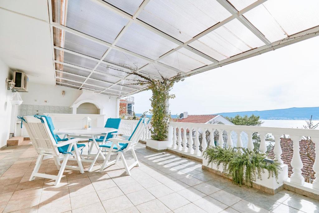 a patio with a table and chairs on a balcony at Bayview Apartments in Tivat