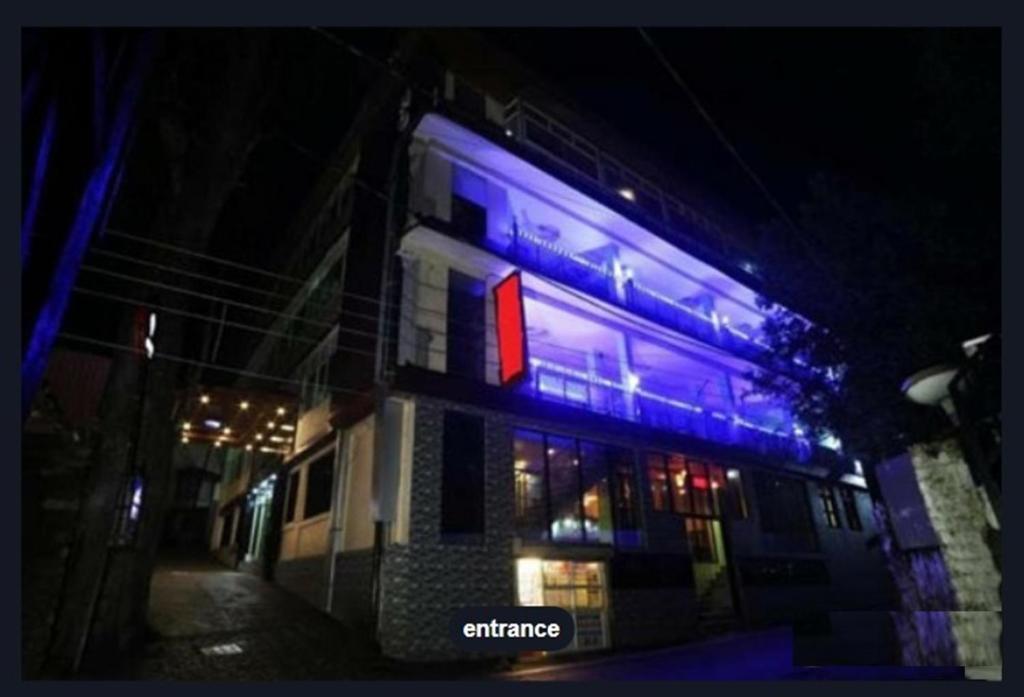 a building with blue lights on the side of it at Hotel Moon by Excellent Hospitality in Nainital