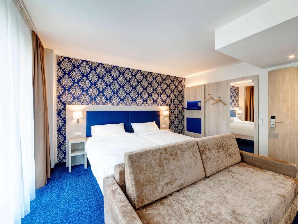 Ein Bett oder Betten in einem Zimmer der Unterkunft ibis Styles Rastatt Baden-Baden