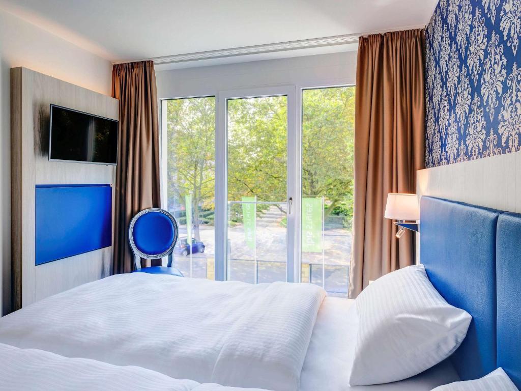 Ein Bett oder Betten in einem Zimmer der Unterkunft ibis Styles Rastatt Baden-Baden